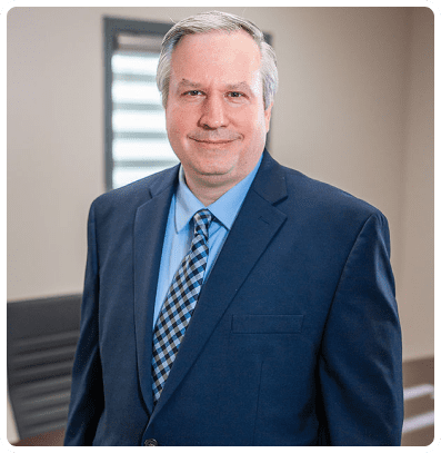 Smiling businessman in blue suit and tie.