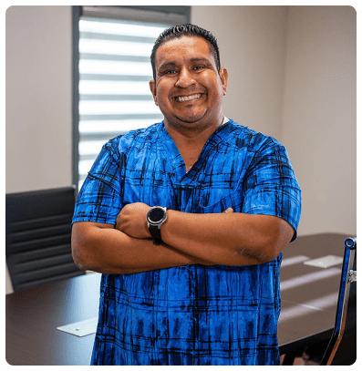 Smiling man in blue checkered shirt.