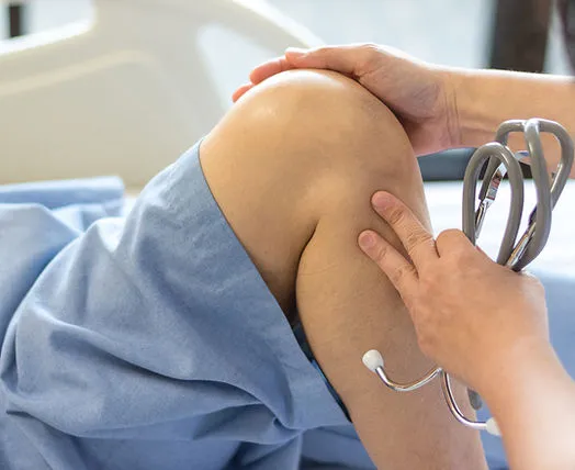 A doctor examining a patient's knee.